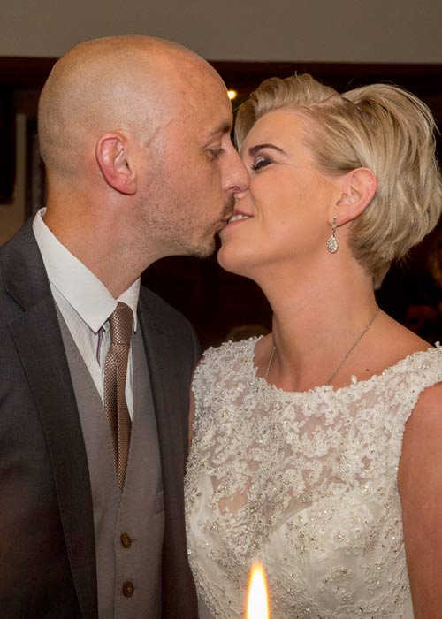 Bride and grooms kiss at the end of their wedding ceremony at Whitley Hall Hotel