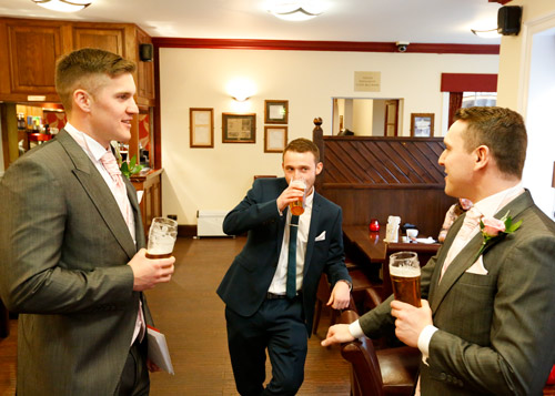 groom and best man having a pint before the wedding cermony