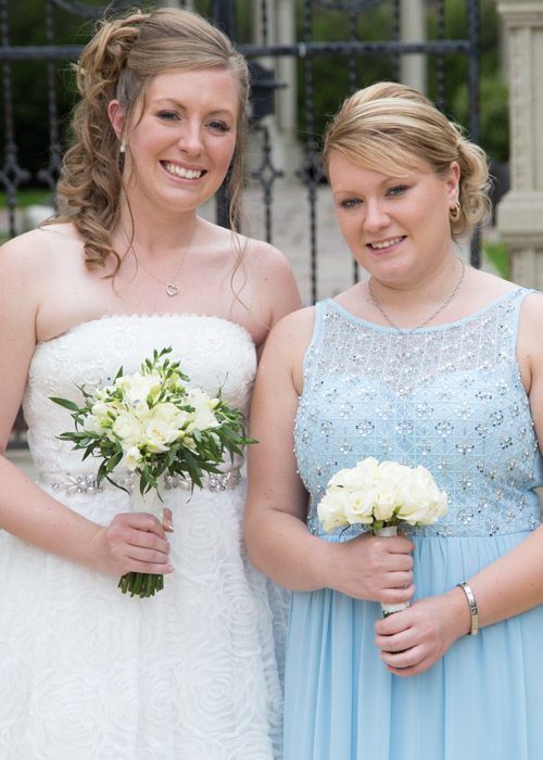 bride and maid of honor with white bouquets outside holiday nn barnsley secret garden