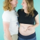 couple laughing maternity session baby on board