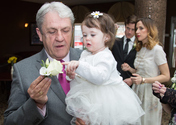 father of the groom and flowergirl playing with a white rose holiday inn barnsley