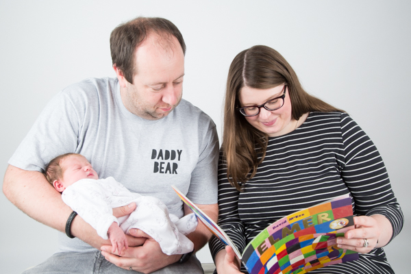 Parents reading Elmer to newborn baby best 24 children's books