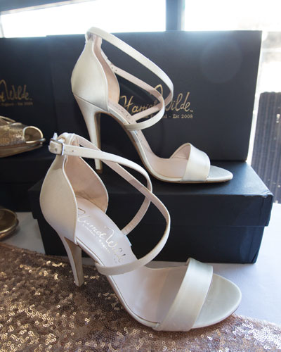 Bride surrounded by Harriet Wilde shoes trying on one of the styles at Harriet Wilde shoe and accessory event March 2017