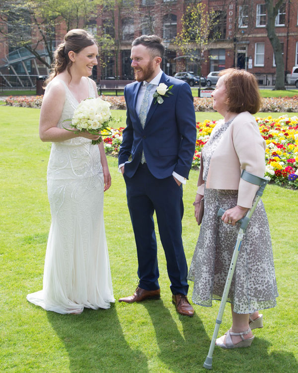 Bride and Groom talking to wedding guests in Park Square Leeds