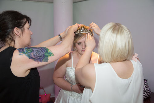Marie and Becca placing tiara in models hair in the Rigby Suite Barnsley