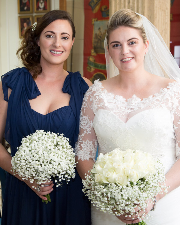 Bride and Bridesmaid holding their bouquets in Barnsley Town Hall before the wedding ceremony bespoke wedding photography