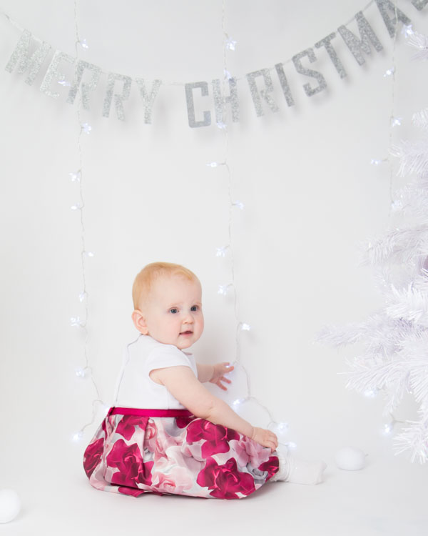 Baby playing with Christmas lights Christmas photo shoots