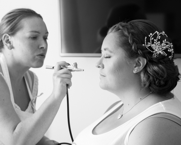 Black and white bride having makeup airbrushed by makeup artist chester