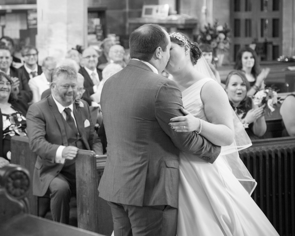 Bride and groom kiss at the end of the wedding ceremony