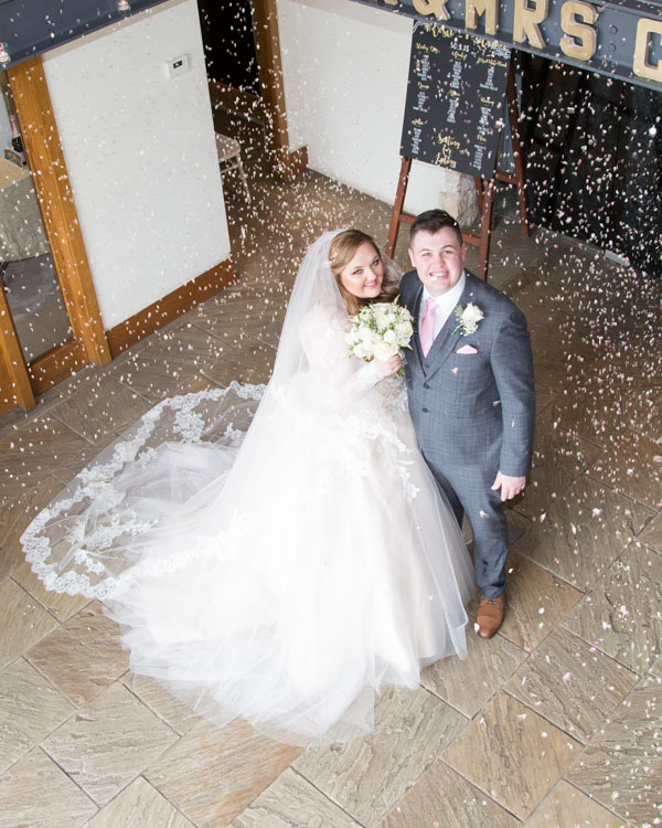 Bride and Groom surrounded by confetti