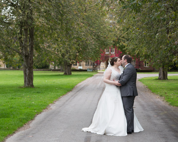 Bride and Groom kissing in between trees at Thoresby Hall Wedding