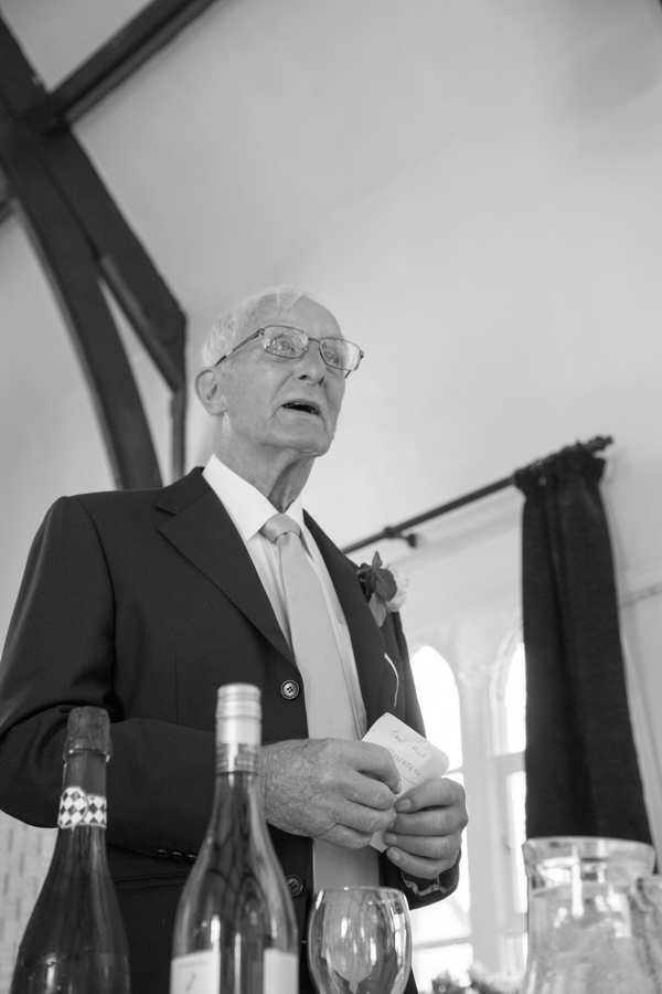 Bride's father giving a speech in black and white at Cawthorne Village Hall