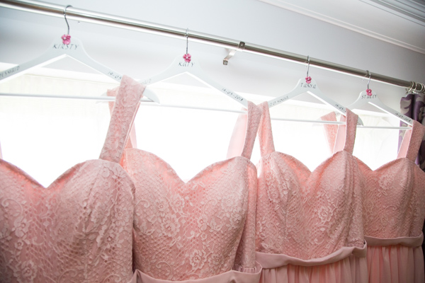 Pink bridesmaid dresses hung on personalised hangers at Burntwood court hotel.