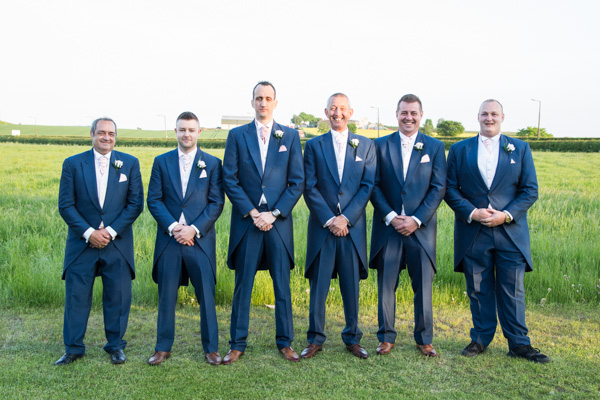 Groomsmen in a row outside Burntwood Court Hotel