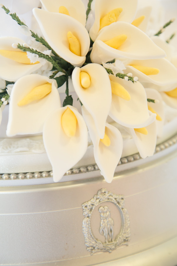 Sugar flower detail on a four tier wedding cake photographer evening reception