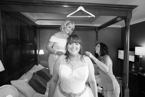 Bride getting into her wedding dress at Tankersley Manor Wedding