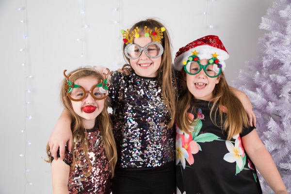 Sisters in Christmas fancy dress during a studio session