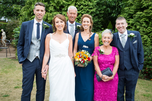 Bride and Groom with their family at Rogerthorpe Manor Wedding