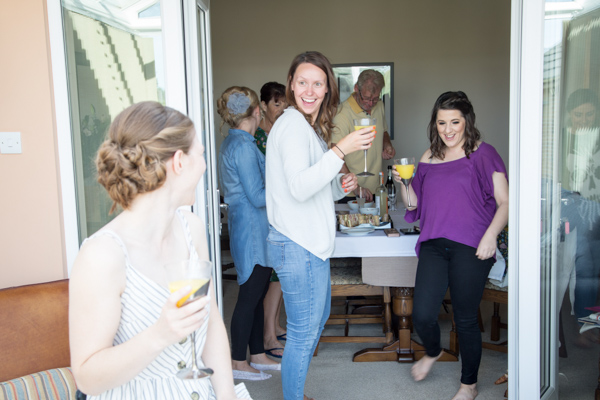 Bridal party drinking bucks fizz while getting ready