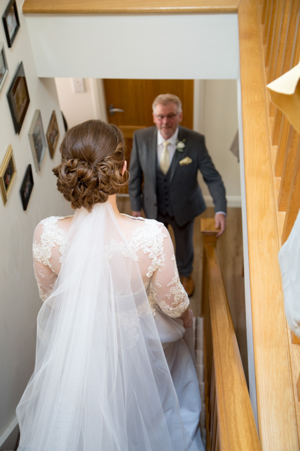 Bride walking down stairs to her Dad