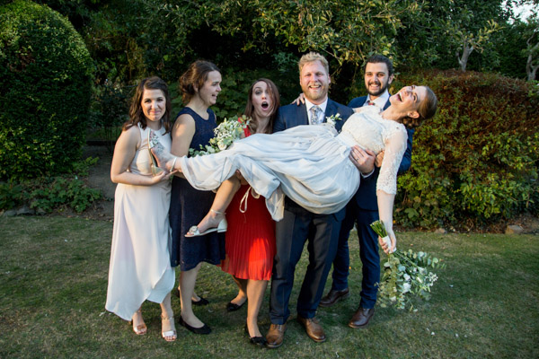 Bridal party holding up bride at The Rockingham Arms Wentworth Wedding
