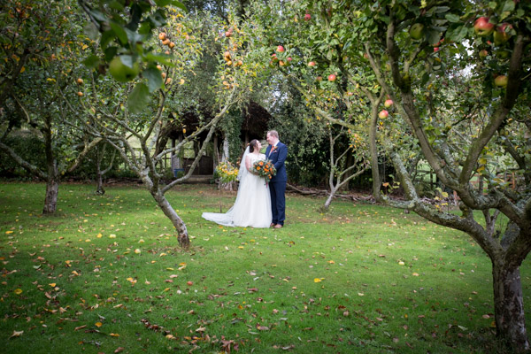 Bride and groom in the apple orchard at Horsleygate Hall Derbyshire