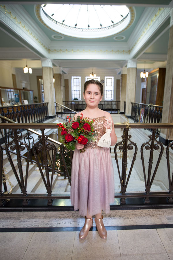 Flower girl holding the rings and her bouquet at Barnsley Town Hall Wedding