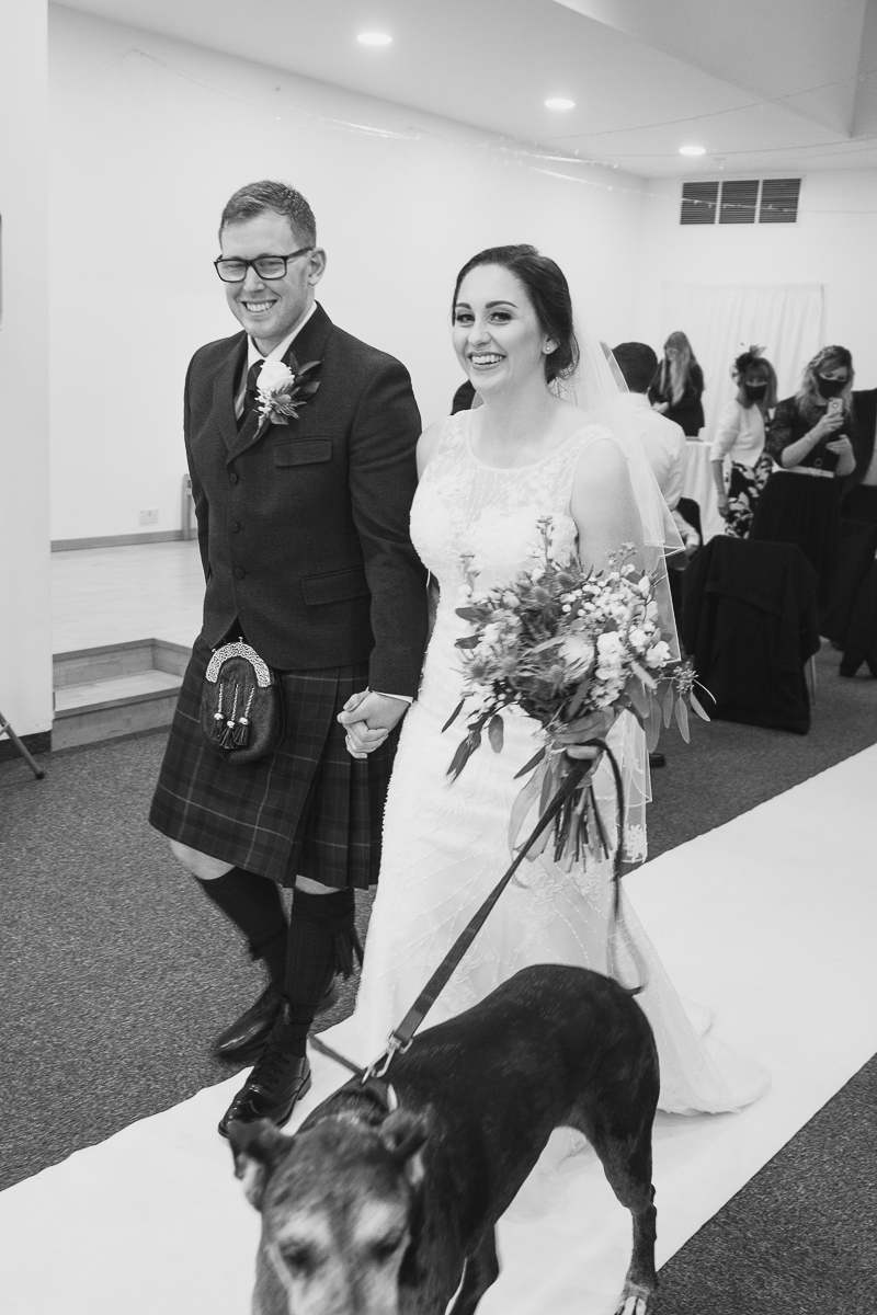 Couple walking back up the aisle with their dog at Yorkshire Sculpture Park Wedding West Yorkshire