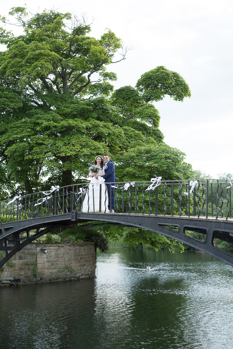 Bride & groom on the bridge at Waterton Park Hotel