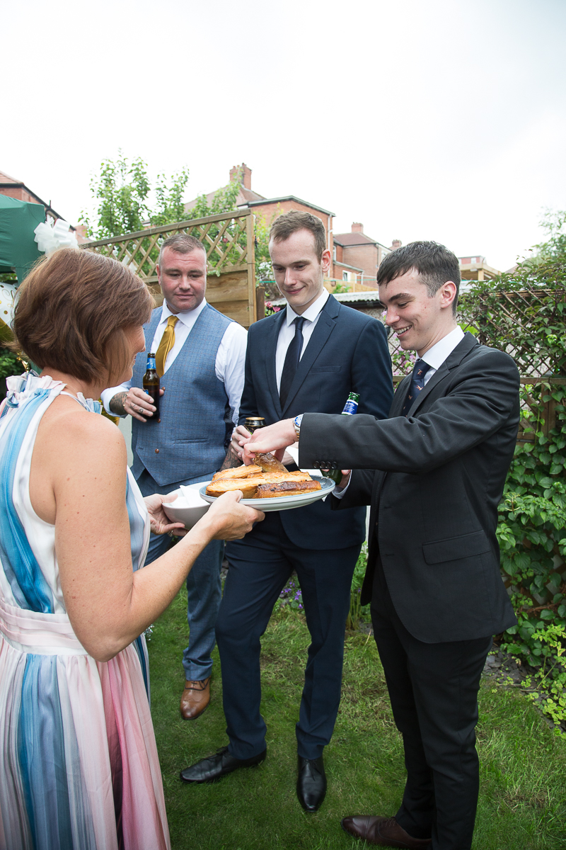 Gusts laugh during back garden wedding reception for a covid wedding