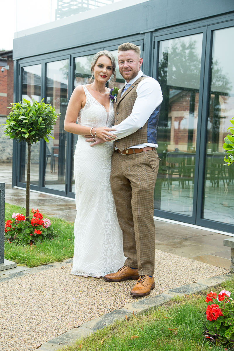 Bride and Groom in the grounds of Burntwood Court Hotel