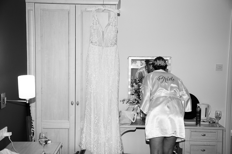 Bride looking in the mirror at Burntwood Court Hotel Wedding