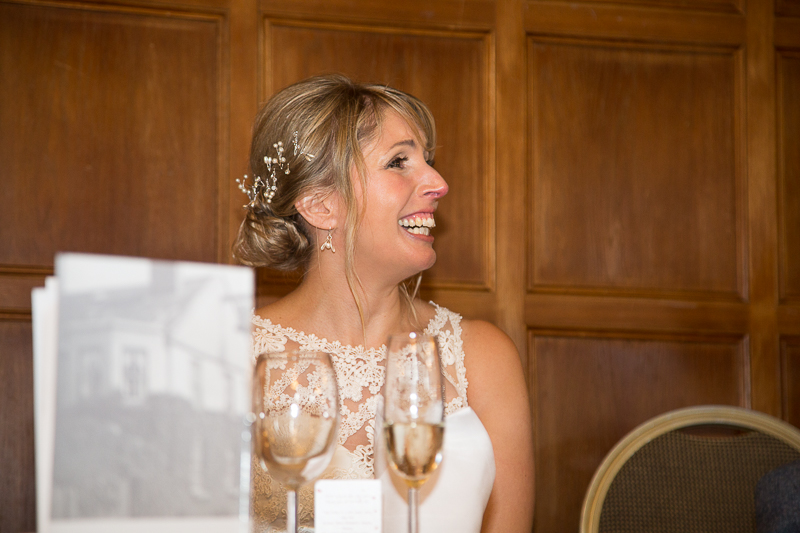 Bride laughing during wedding speeches