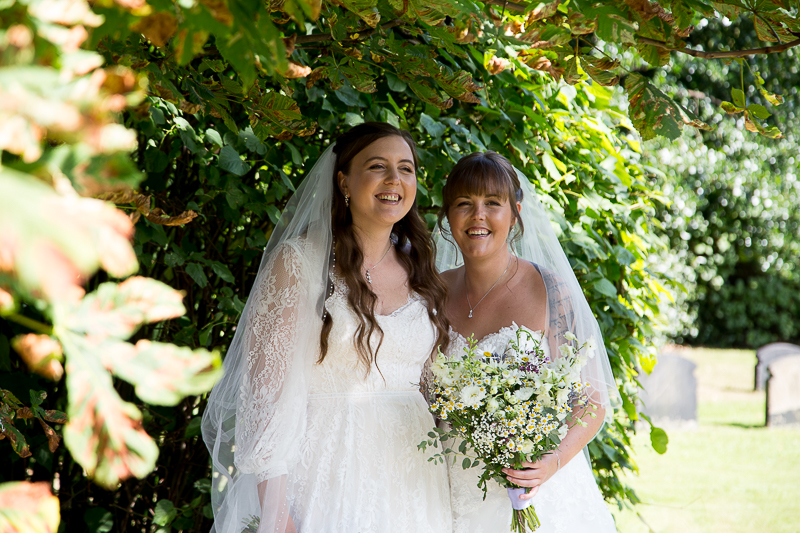 Brides laughing under a tree in Barnsley South Yorkshire Wedding photographer