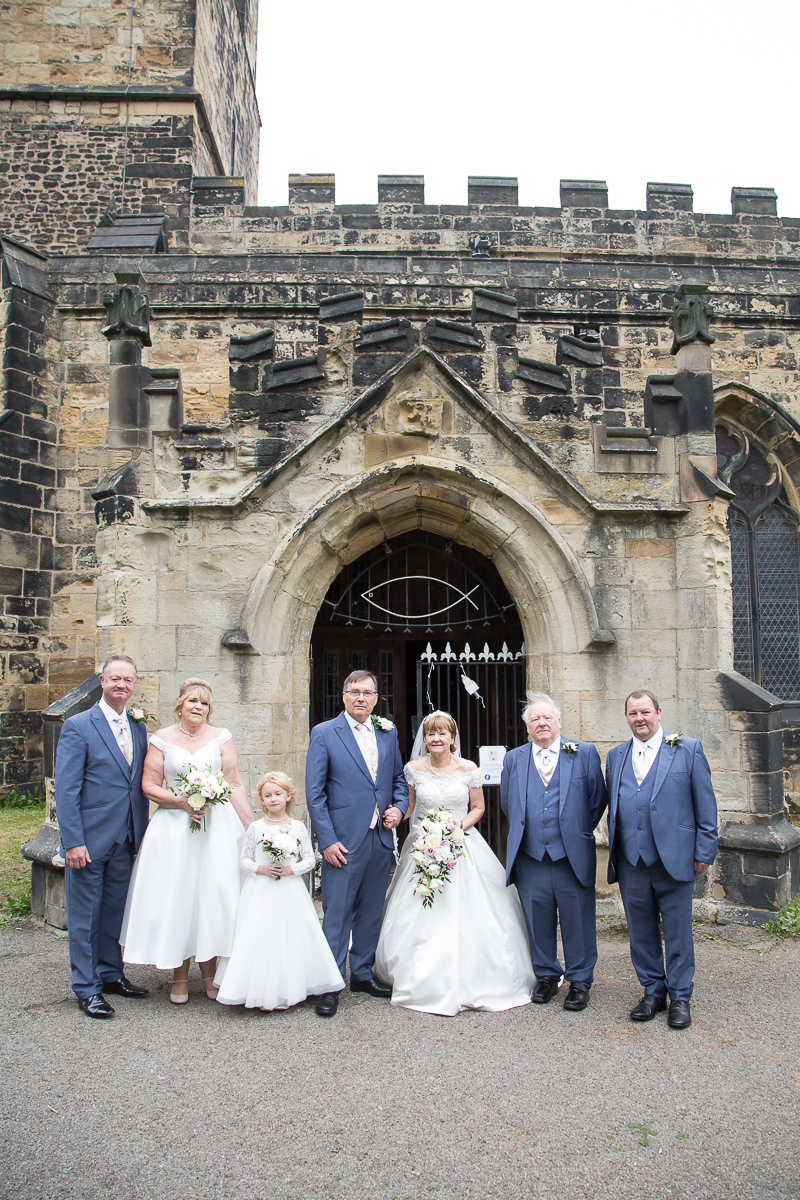 Group shots in the grounds of All Saints Church Darfield by Charlotte Elizabeth Photography wedding photographer south yorkshire