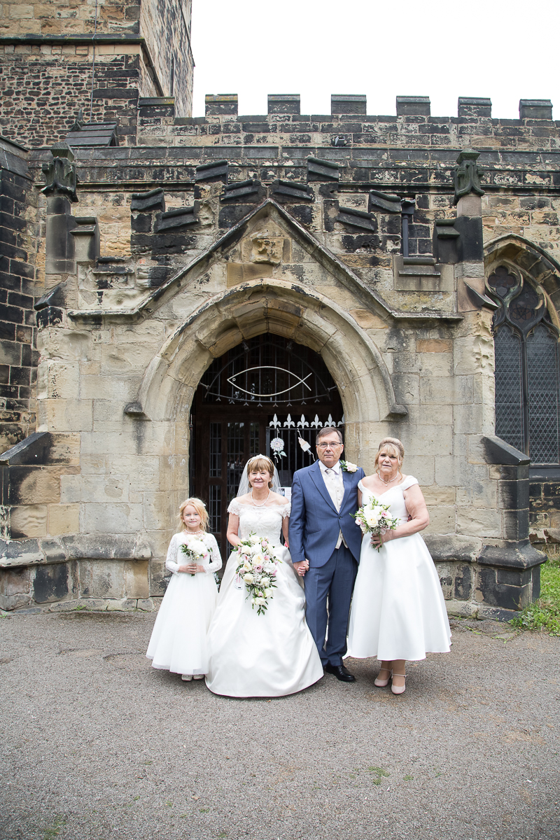 Group shots in the grounds of All Saints Church Darfield by Charlotte Elizabeth Photography wedding photographer south yorkshire