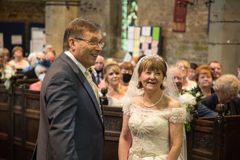 The bride and groom exchanging vowes at All Saints Church Darfield