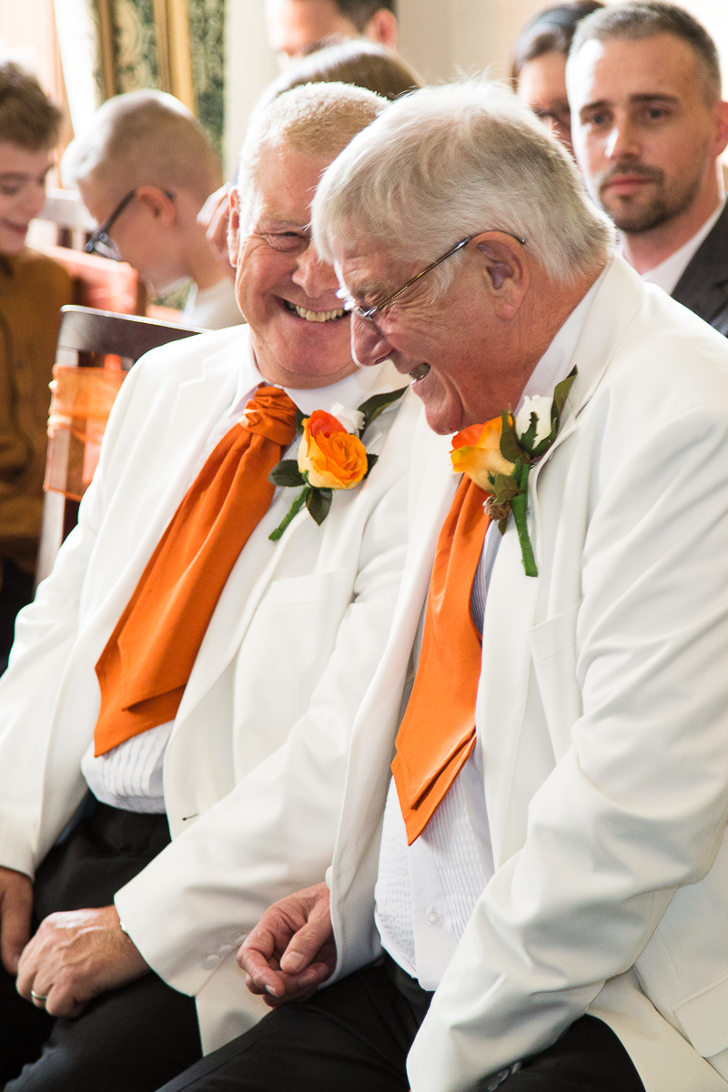 Groom and best man laughing together in the ceremony room at Wortley Hall Hotel Sheffield