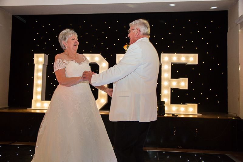 The first dance in front of led white light up love letters on a light up dancefloor at Wortley Hall Hotel Sheffield