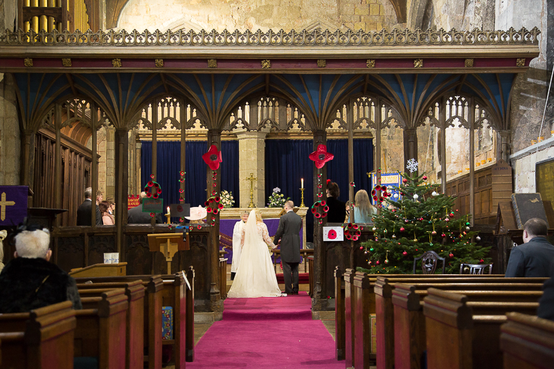 bride and grom at the high altar at St Mary & St Martin's Church Blyth