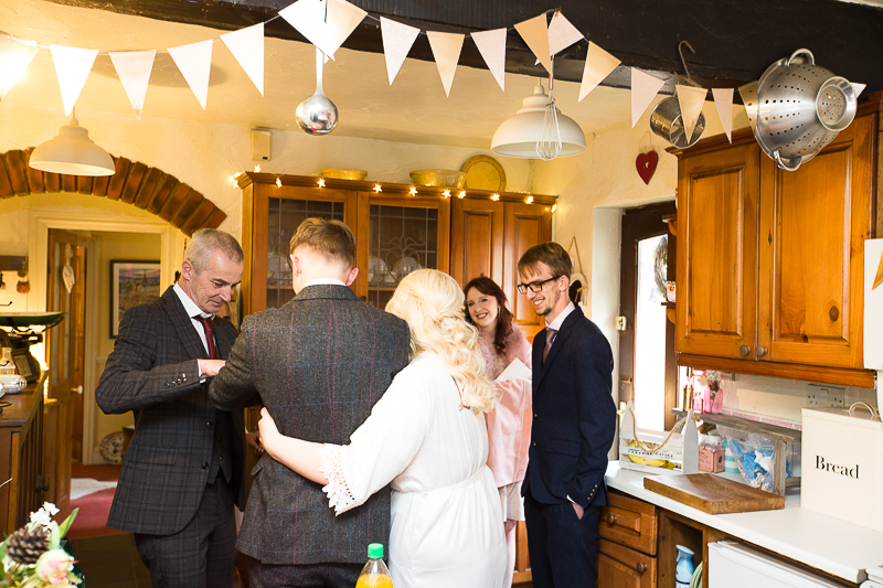 Bridal party talking in the kitchen on the mornign of the wedding captured by Wedding photographer south Yorkshire