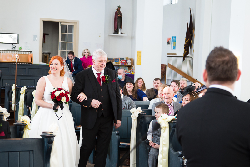 Bride walking down the aisle in St Peter's church Warmsworth