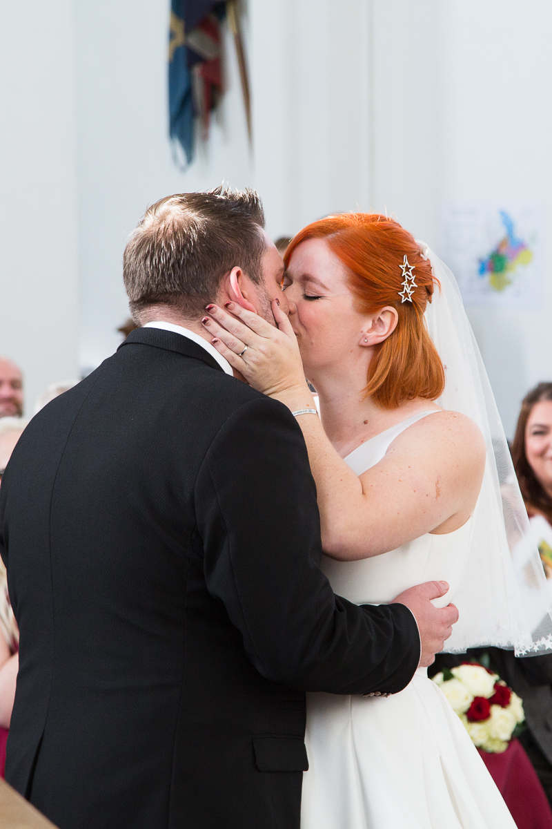 First kiss as husband and wife at the end of the wedding ceremony in St Peter's church Warmsworth