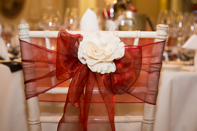 Red bow with white rose on the back of spindle chair