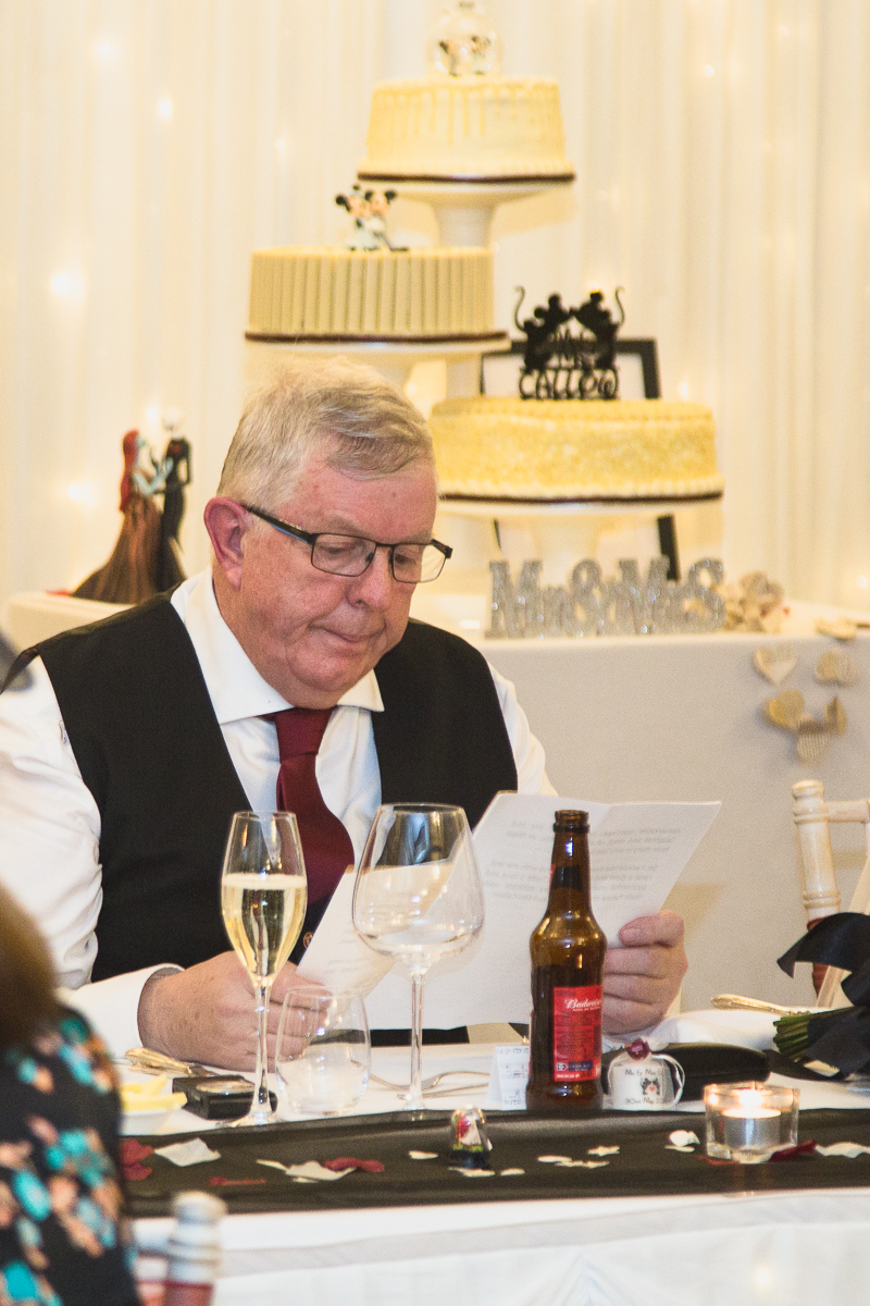 Father of the bride reading his speech before standing up