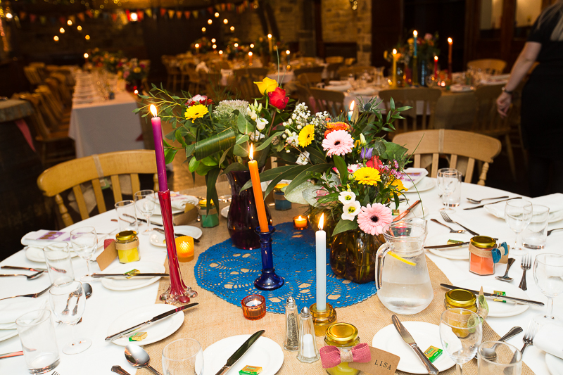 Bright flowers and candles as centrepieces at Cubley Hall Hotel Wedding
