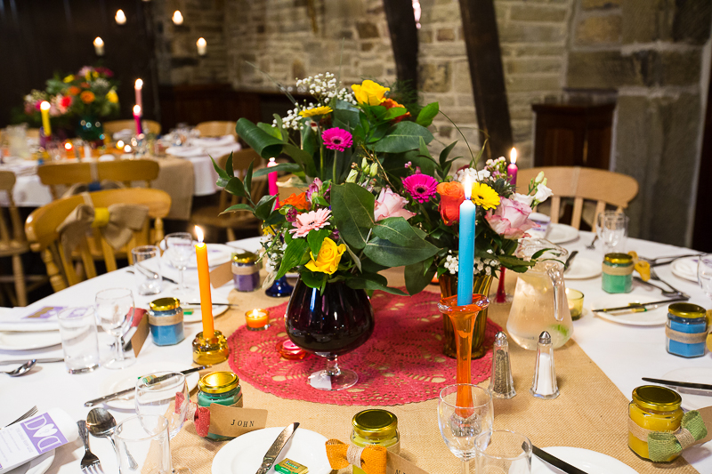 Bright flowers and candles as centrepieces at Cubley Hall Hotel Wedding