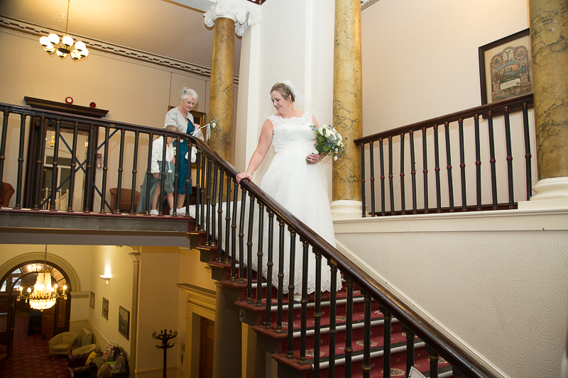 The bride walking down the staircase at an intimate January wedding at Wortley Hall Sheffield
