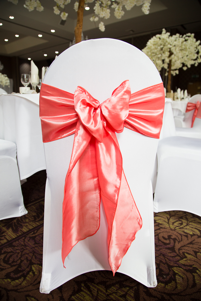 The wedding breakfast room decorated with cerise pink decorations at Burntwood Court Hotel