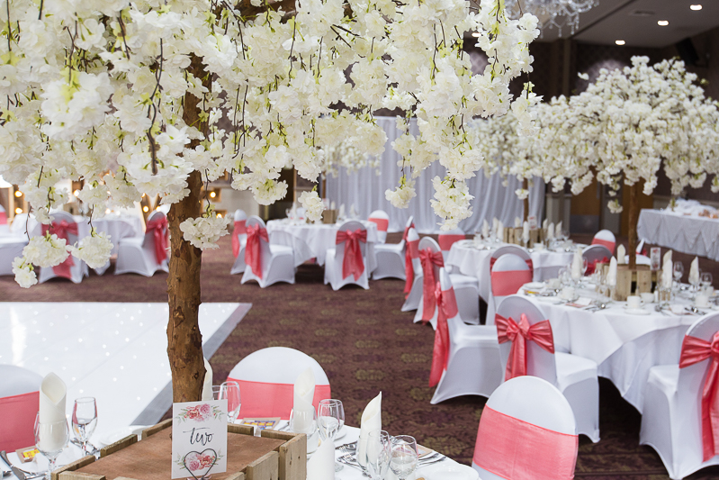 The wedding breakfast room decorated with cerise pink decorations at Burntwood Court Hotel